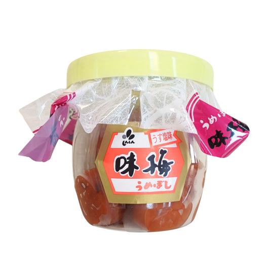 Jar of pickled plums with a yellow lid and red label on a white background